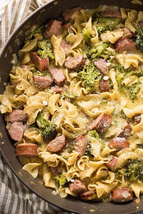 This recipe features smoked sausage (any kind, but i used a super yummy chicken andouille sausage to make it a bit lighter), frozen chopped spinach, and farfalle pasta, with parmesan cheese and heavy cream stirred. Cheesy Smoked Sausage One Pot Pasta - The Salty Marshmallow