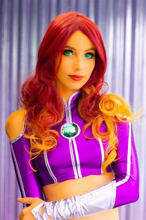 She has green eyes, orange skin and auburn hair. Starfire Cosplay