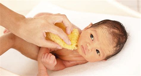 Keep baby covered during the bath. Bathing your newborn | BabyCenter