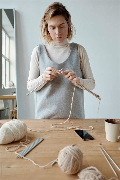 Crafty Woman Knitting In Studio by Clique Images
