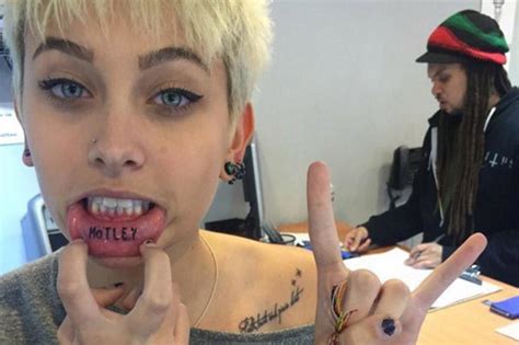 Now she's revealing that there's more to her ink than meets the eye. Paris Jackson Gets Motley Crue Tribute Tattoo on Lip