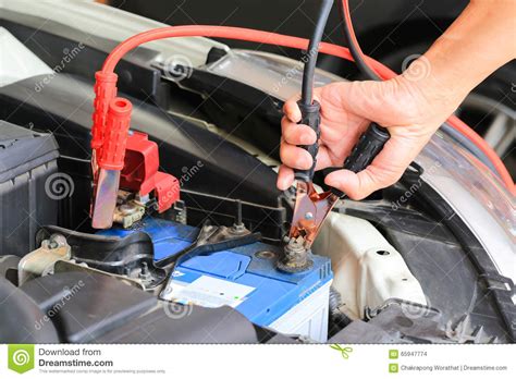 Take out your jumper cables. Car Mechanic Uses Battery Jumper Cables Charge A Dead ...