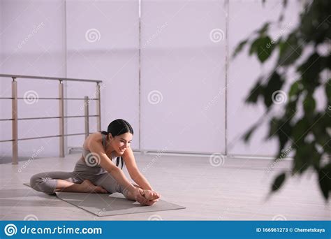However, it's also the pose that is most frequently reported to cause adverse affects, some of which have been very serious. Woman Stretching Leg In Yoga Studio. Janu Sirsasana Pose Variation Stock Image - Image of ...