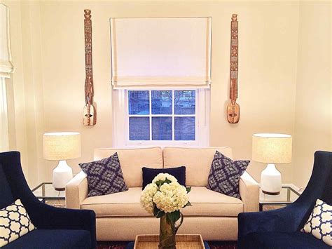 Cream and blue living room design features a blue sofa accented with blue pillows, cream fretwork chairs accented with blue pillows atop a tan jute rug, a dark brown bamboo trellis magazine rack, illuminated by a moroccan star pendant. 14 Incredible Navy Blue And Cream Living Room Ideas | Blue ...