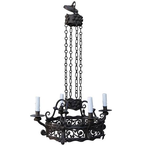 The outer most diameter is 49.5 inches. Spanish Four-Light Wrought Iron Chandelier For Sale at 1stdibs