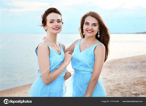 Two young girls posing on the beach. Beautiful young girls on beach — Stock Photo © belchonock ...
