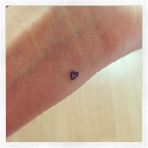 Blue heart tattoo on wrist. Wrist heart tattoo | Tiny heart tattoos, Trendy tattoos ...