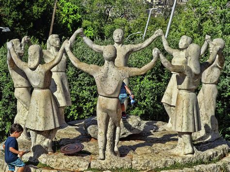 To dance the sardana, people give hands, joining in a circle. Sardana Dance Statue - Barcelona Photograph by Allen Beatty