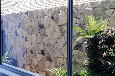 Designer stone, rock face cladding, split face tiles, stone for modern walls, interior stone, exterior stone tiles. Exterior Stone Wall - Heazlewood Tiling and Cladding Service