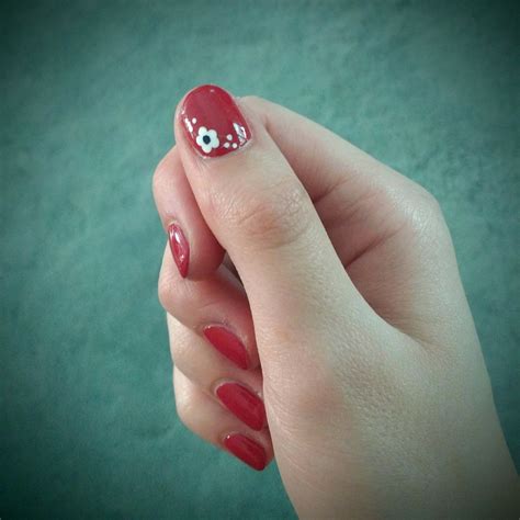 Maybe you would like to learn more about one of these? Red nails with white flower accent #nails #nailpolish # ...