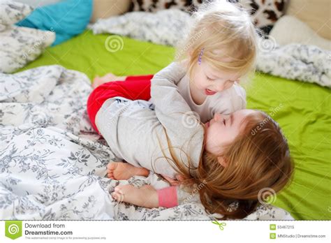 Oleh karena itu admin sangat bersemangat untuk membahasnya, karena kebanyakan orang sangat susah meencari film ini. Two Little Sisters Playing In Bed Stock Photo - Image ...