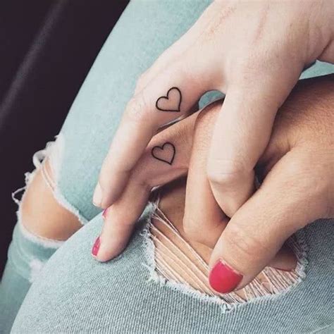 Finger tattoos on the inside of fingers tend to fade quicker than those on top. small-hearts-inside-finger-tattoos-for-moms-ripped-jeans ...