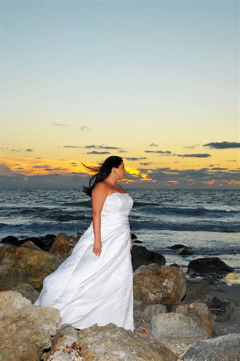 Food and beverage were great. Bride on the rocks at sunset | Florida beach wedding ...