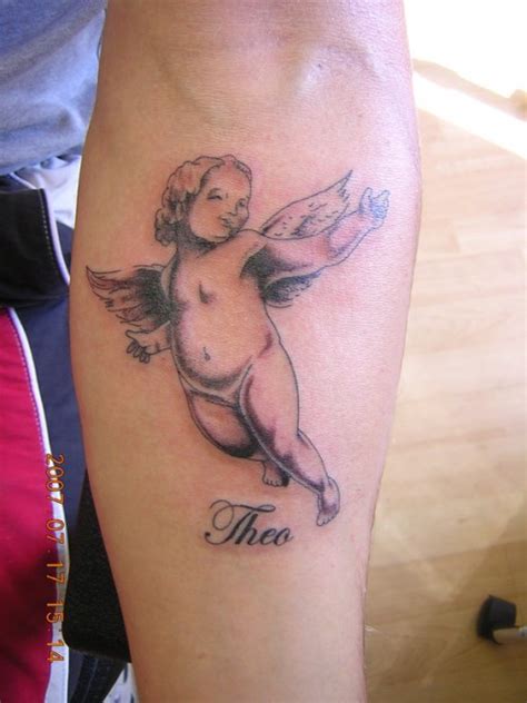 A baby sleeping in wings or feet with angel wings represents baby angel tattoos for miscarriage. Baby Angel Tattoo Designs | Fashion Club