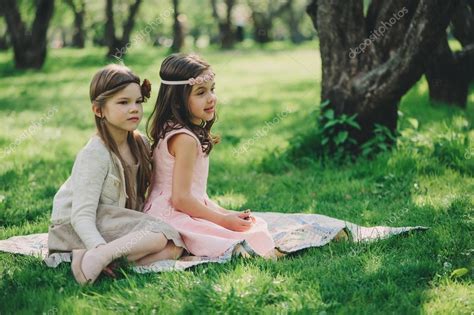 Girls playing together free photo. Happy little girlfriends playing together in spring park ...