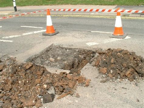 Trial pit showing bituminous road pavement, pitchings and ...