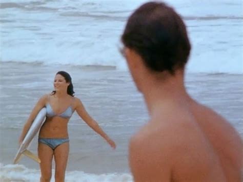 American surfer and director bruce brown surfs a wave and holds a camera while filming footage for his international surfing documentary, 'the endless summer,' circa 1966. Surf City, exhibition, Museum of Sydney - Part 15