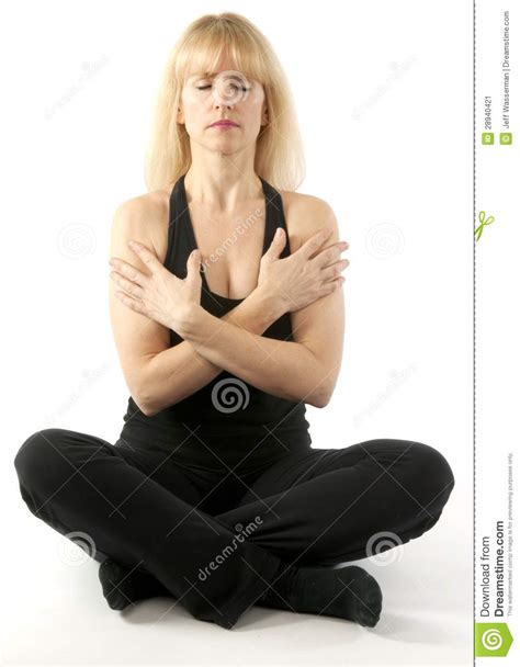 Attractive blonde sportswoman doing stretching exercise standing feet wide apart leaning forward resting on body bar in. Mature Blond Woman Doing Yoga Stretching Exercise Stock ...