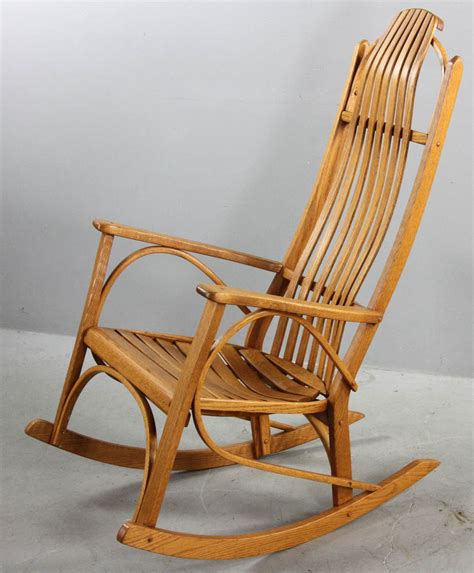 Rocking chair made of wood with armrests and horizontal wooden struts, the running surfaces of the runners are covered with felt, h.141cm, seat height: Lot Detail - Contemporary Oak Rocking Chair