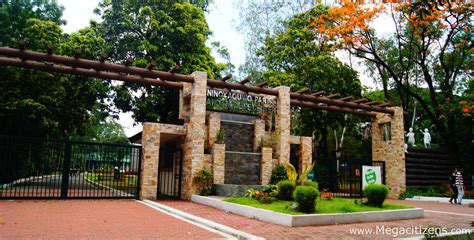 There is a small lake surrounded by walkways, tables and benches where people come to. Ninoy Aquino Parks & Wildlife Center, Philippines 2019