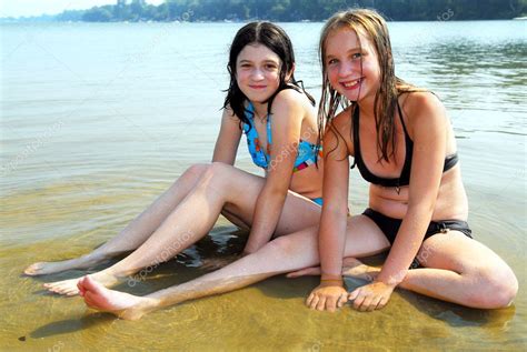 Hopefully, you are ready because we're going to give it to you. Two girls in water — Stock Photo © elenathewise #4826287