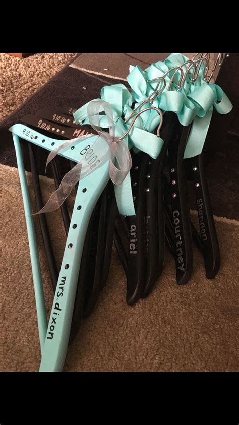Wooden hangers, spray paint, paint markers, and sola wood flowers. DIY Personalized Bridesmaid Hangers. Tiffany Blue, Black & Silver. | Personalized bridesmaid ...
