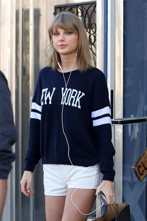 Taylor swift enjoys her time at the beach as she looks amazing in that blue swimsuit and pink hat. Taylor Swift New York - Celeblr