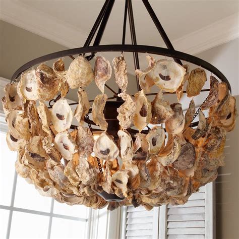 Turn a regular chandelier into the conversation piece of your room with a little patience and a lot of oyster shells! Oyster Shell Basket Chandelier | Shell chandelier ...