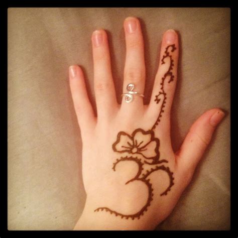 See more ideas about tattoos, henna tattoo, henna designs. Peace out! An OM symbol with flowers | Henna hand tattoo ...