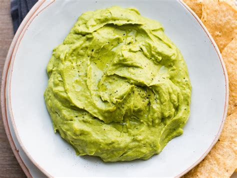 Cut the avocado in half, scoop out the flesh with a spoon; Creamy Guacamole Recipe - Todd Porter and Diane Cu | Food ...