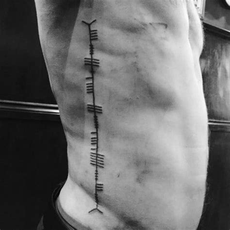 Thus, the rib cage presents a perfect canvas for a tattoo artist, but getting a tattoo here requires a great deal of courage and is not everyone's cup of tea. 50 Ogham Tattoo Designs For Men - Ancient Alphabet Ink Ideas