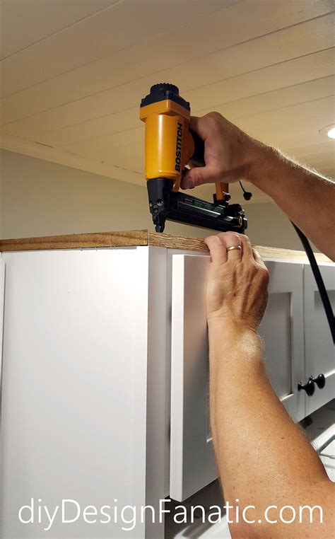Cut the molding according to the measured length. Mr. DIY used scrap wood and nailed it to the top of the cabinet.