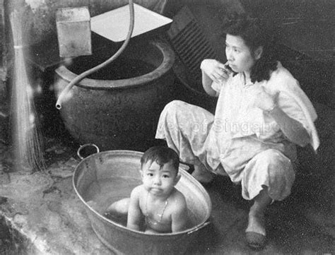 Gather the supplies you'd use for a sponge bath, a cup of rinsing water and baby shampoo, if needed, ahead of time. WOMAN BATHING BABY IN A METAL TUB | Singapore photos ...