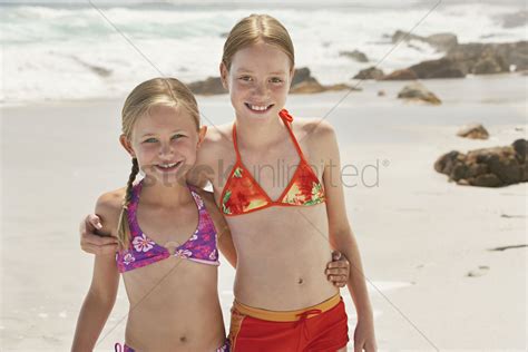 Seems like you liked my innie the last time, so i thought i show you what's inside. Two girls (7-9 10-12) posing on beach portrait Stock Photo ...