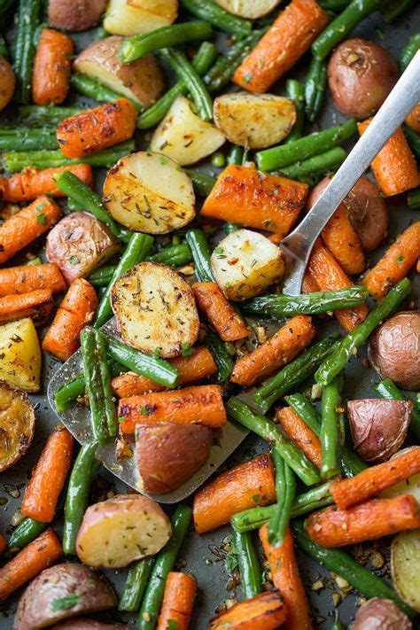 This simple side dish of roasted potatoes, green beans and carrots is perfect to pair with any protein for dinner. Garlic Herb Roasted Potatoes Carrots and Green Beans ...