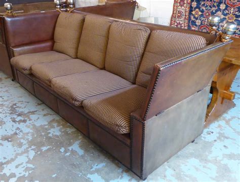 Instead have a ratchet system that means the arms can be put into one of 4 positions. KNOLE SOFA, of substantial proportions, brown leather with ...