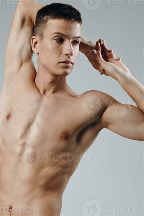 athletic physique young male nude torso gray background portrait