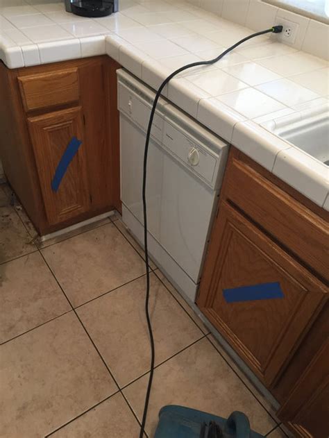 Loose or damaged flooring in front of the sink. water leak and OSHA regulations