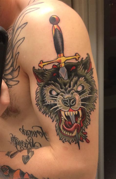 Maybe you would like to learn more about one of these? Wolf head with dagger by Chris Gallegos at Tattoo Demon ...