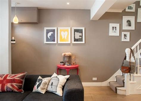 The living room is furnished with claret armchairs (right) and a hexagonal table by rose tarlow melrose house, along with a neutral rug by patterson flynn martin. Opening up the hallway/lounge and dining room/staircase ...