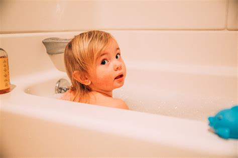 Baby watching the water and bubbles while taking a bath. Our Favorite Natural, Baby Bubble Baths - Live Love Simple