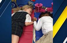 sleeping little girls holding hands mississippi viral school clarksdale two preschool goes nap presbyterian