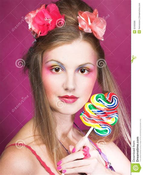 Beautiful young woman with lollipops on color background. Girl With Lollipop Royalty Free Stock Image - Image: 32490086