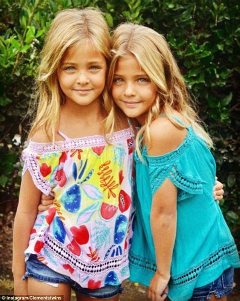 Tee ngirl sitting on old cart at train station. Seven-year-old identical twins win dozens of modelling ...