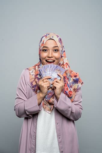 This bears out in the fact that despite malaysia being a former english colony, indonesian now has more english loanwords that are used interchangeably with 'tandas' in indonesian means to accentuate. Excited Young Malay Woman Wearing A Hijab Holding ...
