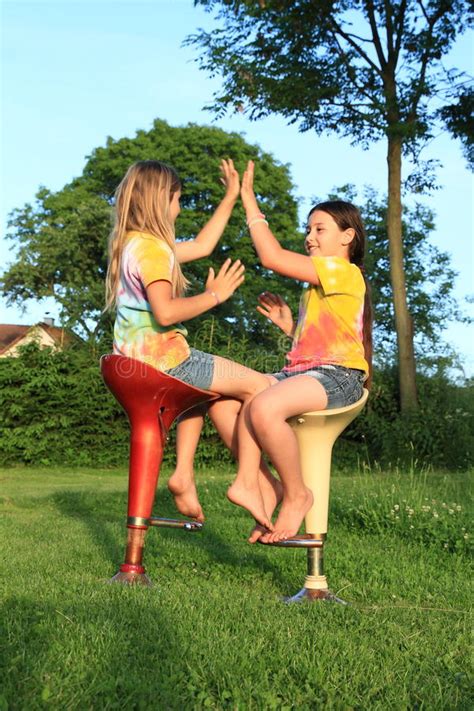 Walk through your school, flirt with all the boys and score points. Two Girls Playing Game While Sitting On Bar Chairs Stock ...