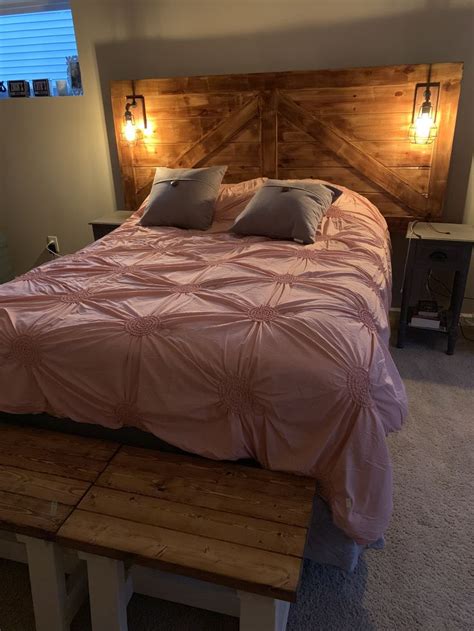 Add an extra set of lights in your room by making this headboard from pine wood, screws, decorative sconces, electric lights, stain, lamp cords, plugs, hammer, screws, bolts, old sock, paintbrush, drill, drill bits, angle grinder, and hand saw. DIY headboard with lights | Barndoor headboard, Headboard ...