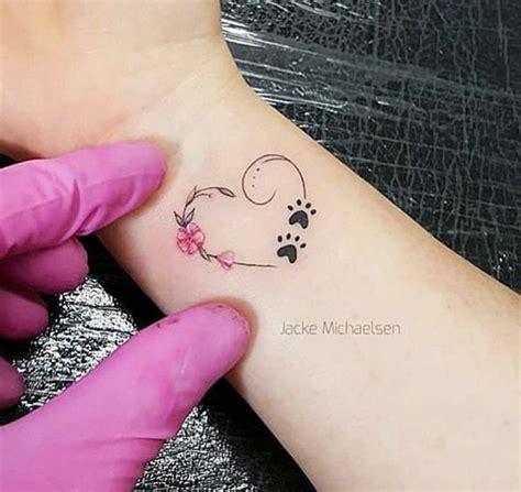 If you're aiming for a larger tattoo that includes multiple elements like hearts, flowers, or the dog design, it'll be over $100. Infinity Dog Paw Print Tattoo On Wrist