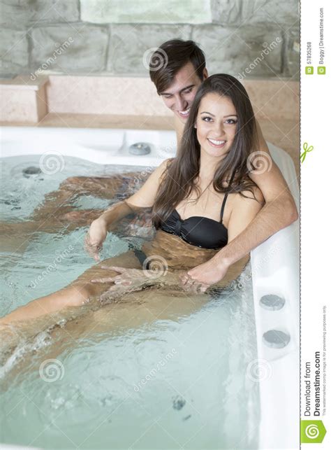 Outside the safari tent is a wood fired hot tub (optional extra), hammock, firepit area and picnic table. Young Couple Relaxing In The Hot Tub Stock Photo - Image of peaceful, male: 57835268