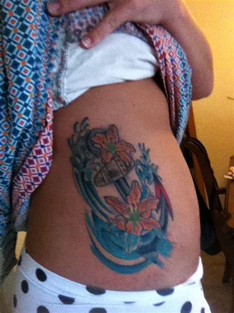 I'm a woman, and i have an anchor tattoo on my forearm. Anchor with water Lillie's dropped into water on rib cage ...